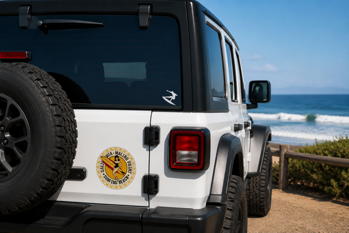 surf decals on white jeep by the beach